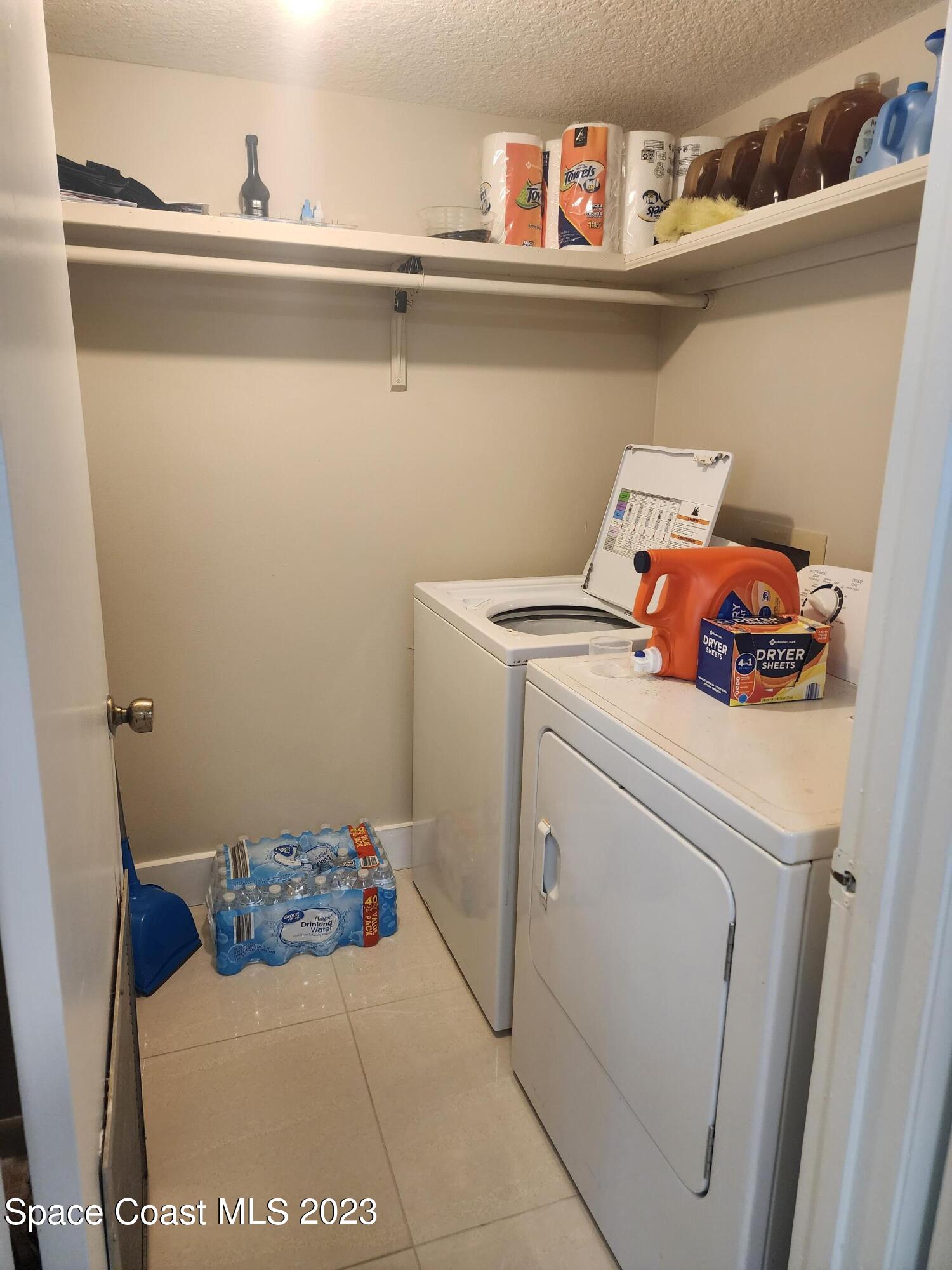 582 North Wickham Road, Unit 89 Melbourne, FL 32934 - Photo 9 of 25 a utility room with dryer and washer