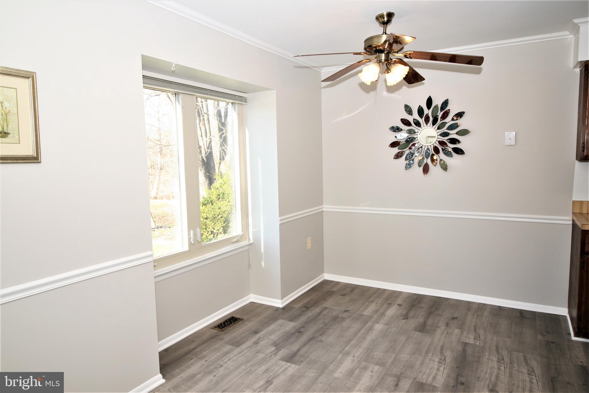 8943 Centerway Road Gaithersburg, MD 20879 - Photo 13 of 34 wooden floor in an empty room with a window