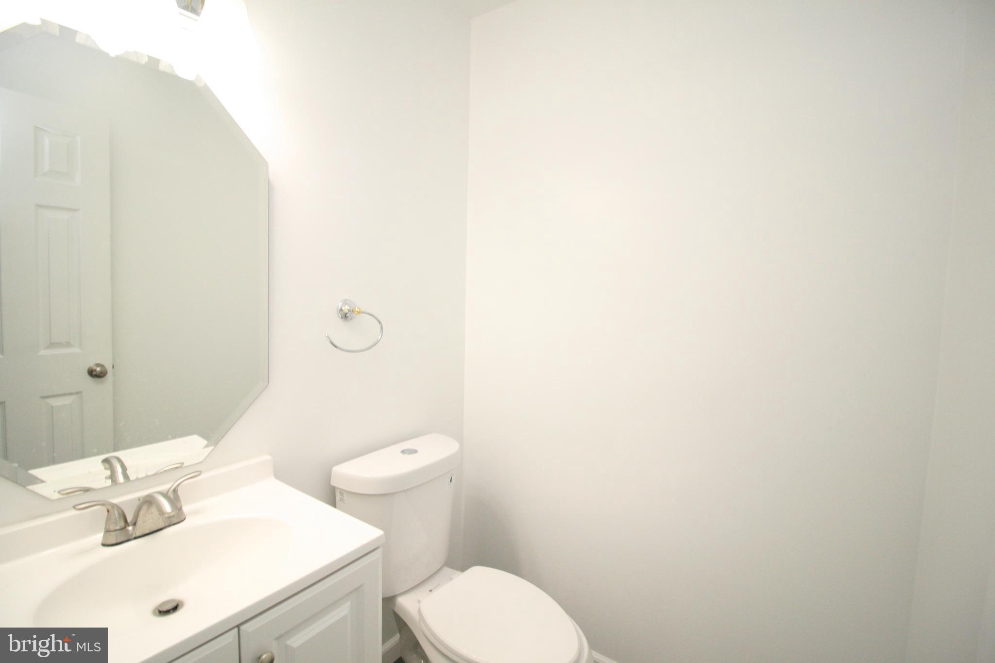 8943 Centerway Road Gaithersburg, MD 20879 - Photo 15 of 34 a white toilet sitting next to a bathroom sink
