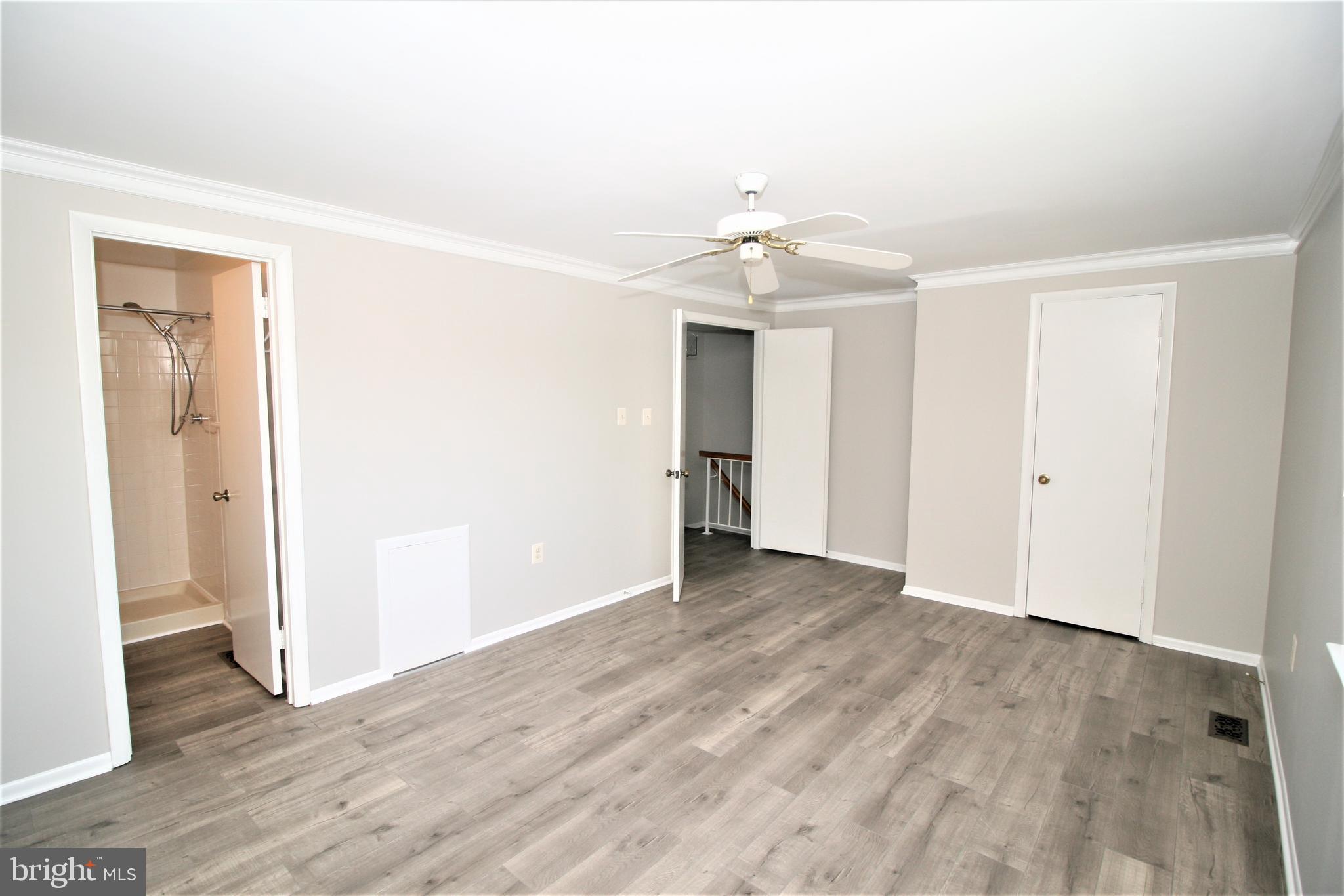 8943 Centerway Road Gaithersburg, MD 20879 - Photo 16 of 34 an empty room with wooden floor and windows