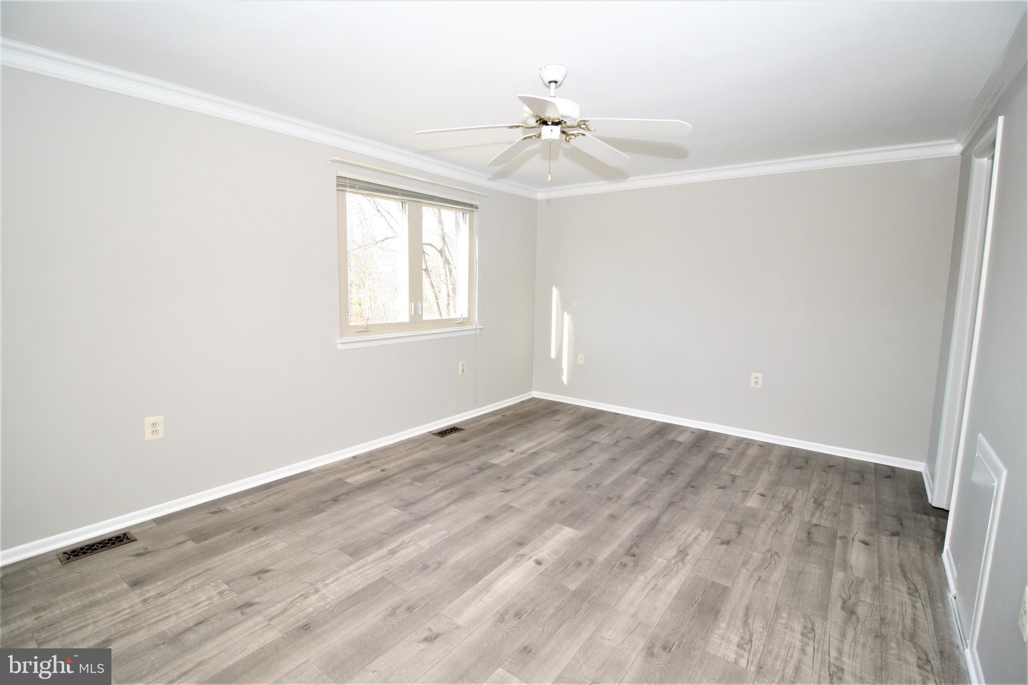 8943 Centerway Road Gaithersburg, MD 20879 - Photo 18 of 34 wooden floor in an empty room with a window