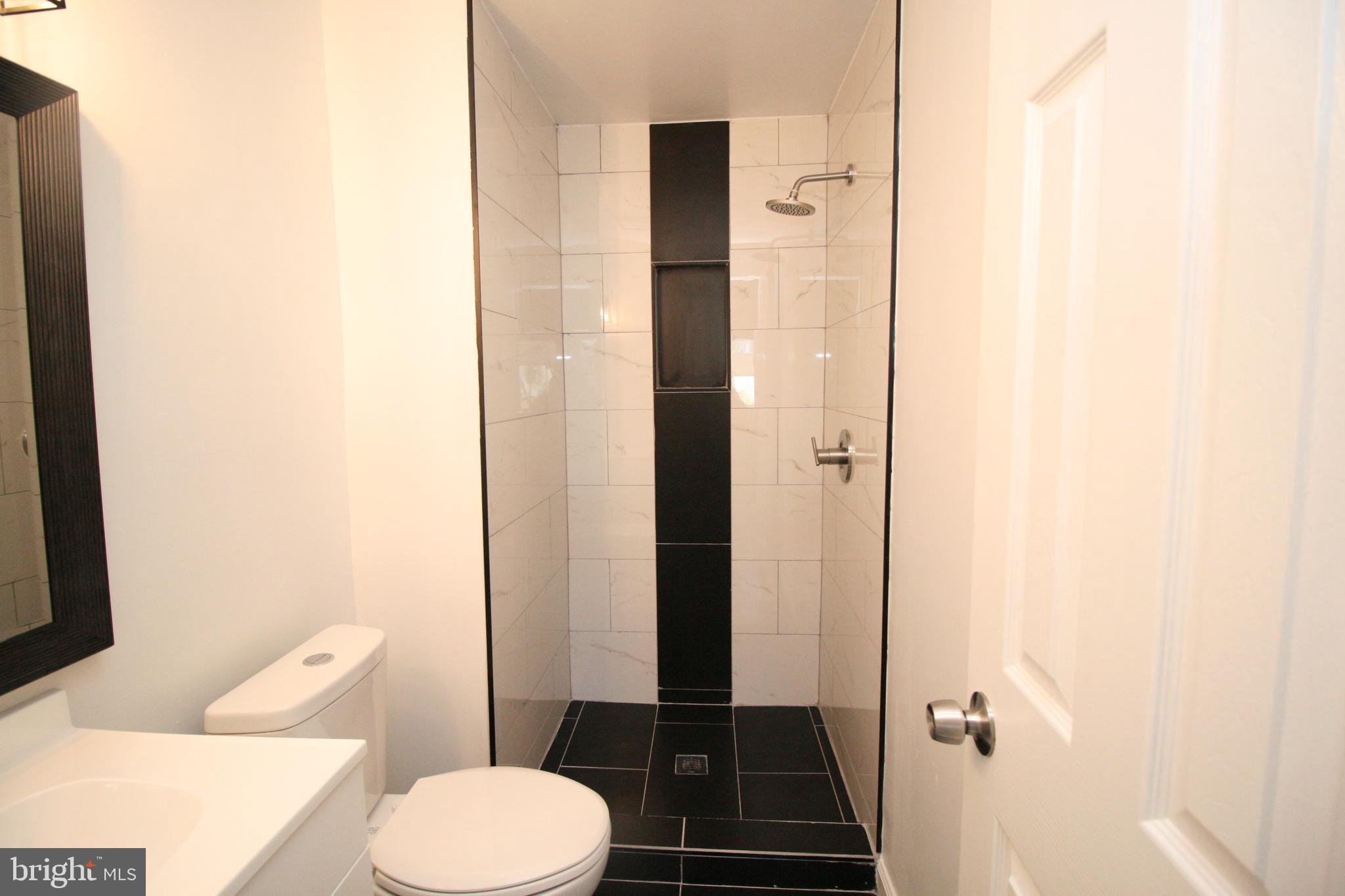 8943 Centerway Road Gaithersburg, MD 20879 - Photo 20 of 34 a bathroom with a toilet and a shower