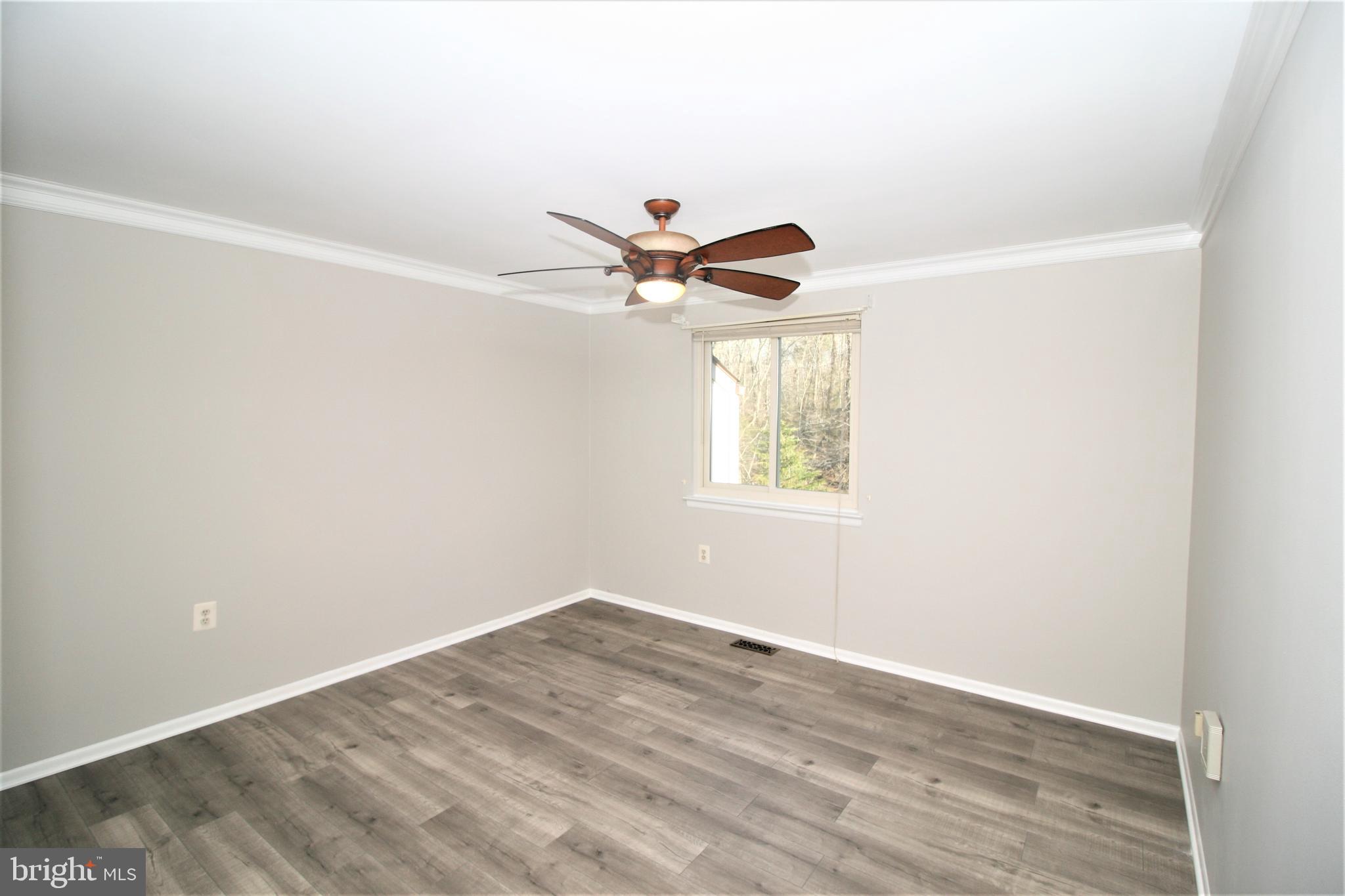 8943 Centerway Road Gaithersburg, MD 20879 - Photo 23 of 34 an empty room with a window and a ceiling fan