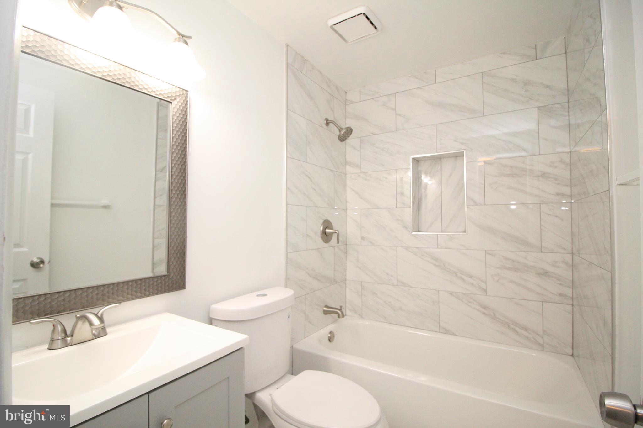 8943 Centerway Road Gaithersburg, MD 20879 - Photo 26 of 34 a bathroom with a sink toilet and shower