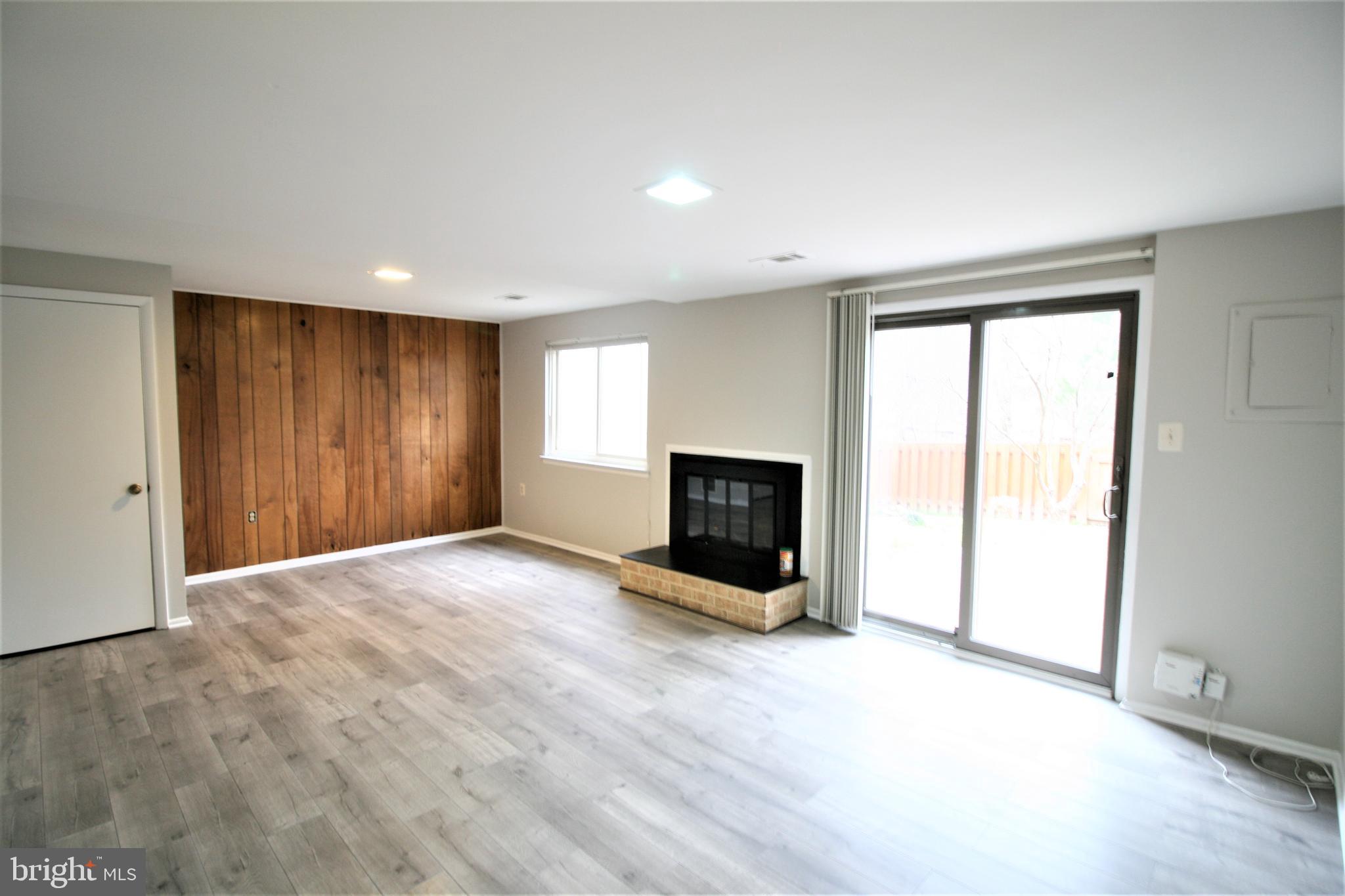 8943 Centerway Road Gaithersburg, MD 20879 - Photo 27 of 34 a view of an empty room with a fireplace and a window