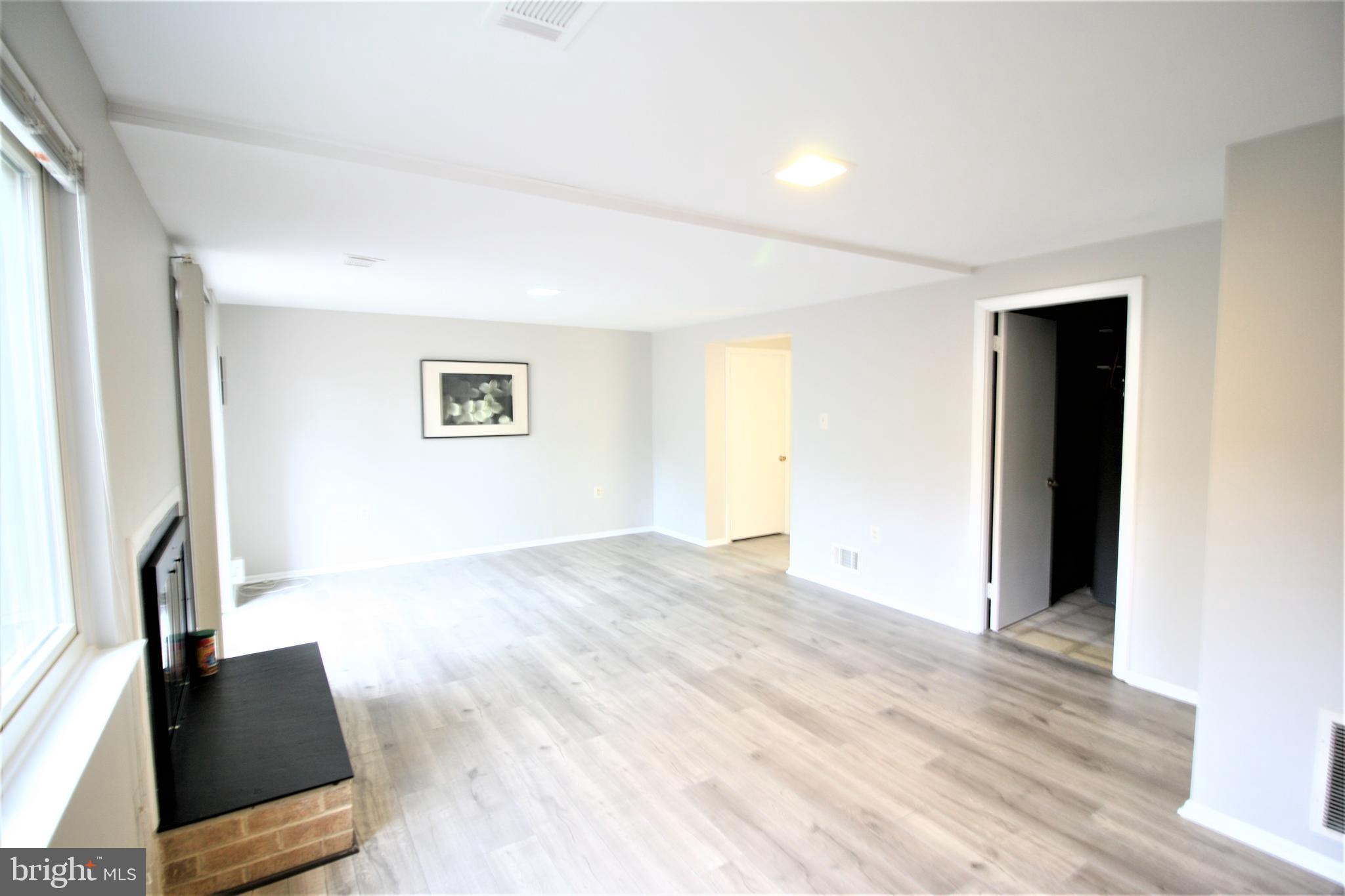 8943 Centerway Road Gaithersburg, MD 20879 - Photo 28 of 34 a view of an empty room with wooden floor and a window