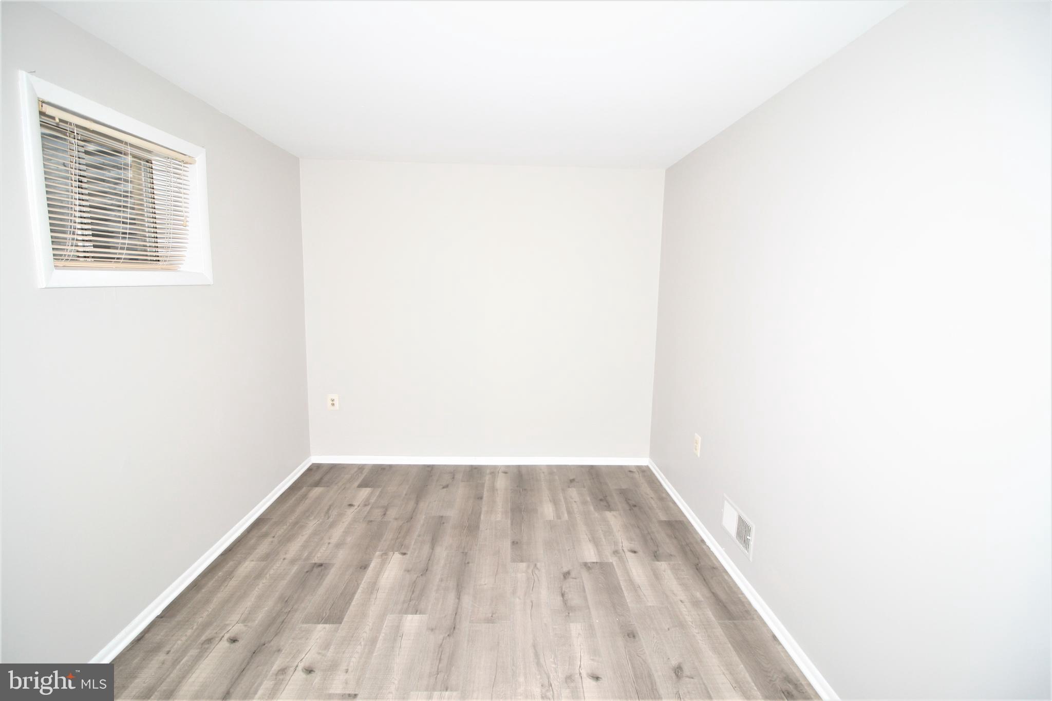 8943 Centerway Road Gaithersburg, MD 20879 - Photo 30 of 34 a view of a room with wooden floor and a window