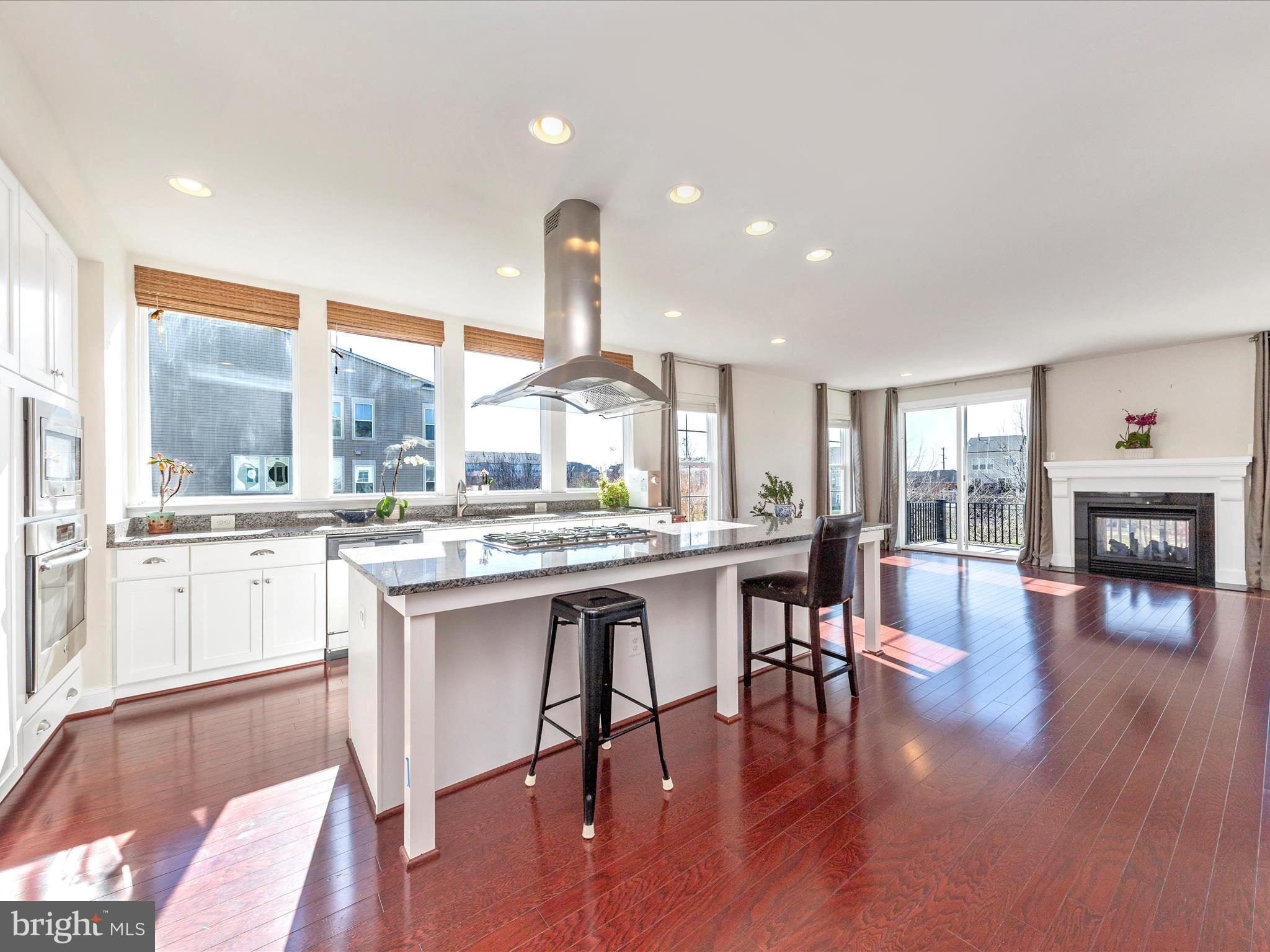 42251 Riggins Ridge Terrace Brambleton, VA 20148 - Photo 11 of 62 a kitchen with a table chairs stove and kitchen view