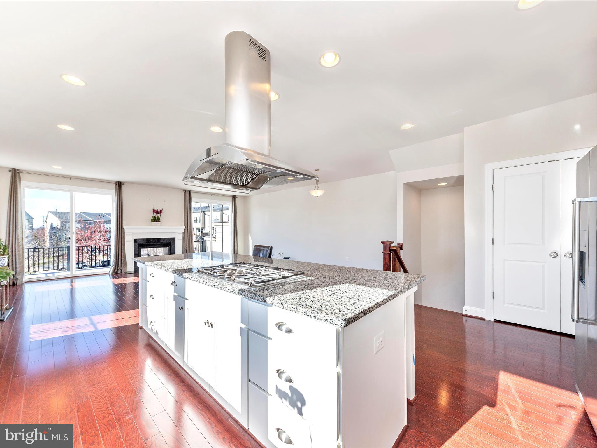 42251 Riggins Ridge Terrace Brambleton, VA 20148 - Photo 17 of 62 a kitchen with stainless steel appliances granite countertop a stove and a refrigerator