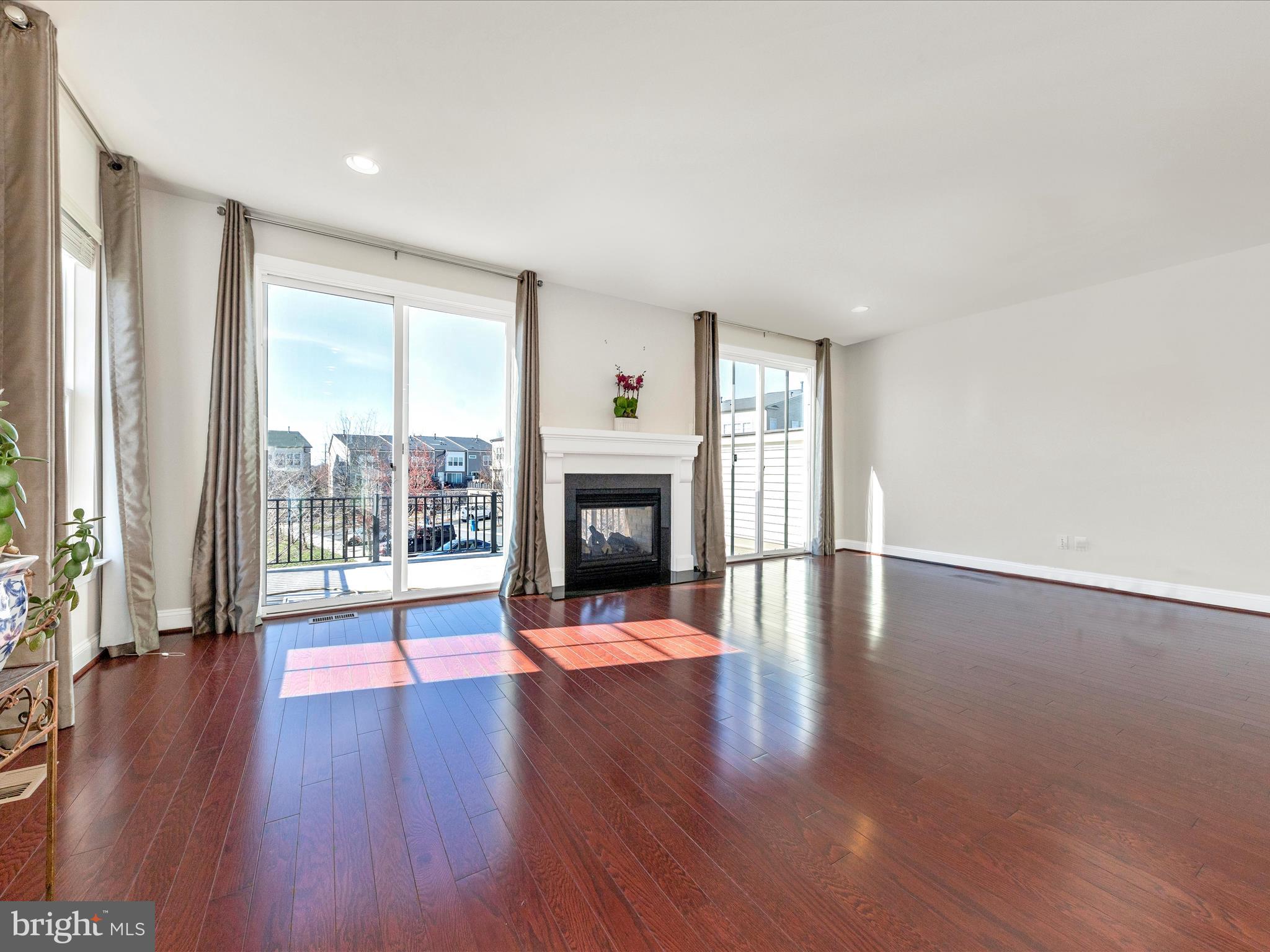 42251 Riggins Ridge Terrace Brambleton, VA 20148 - Photo 21 of 62 a view of an empty room with wooden floor and a window