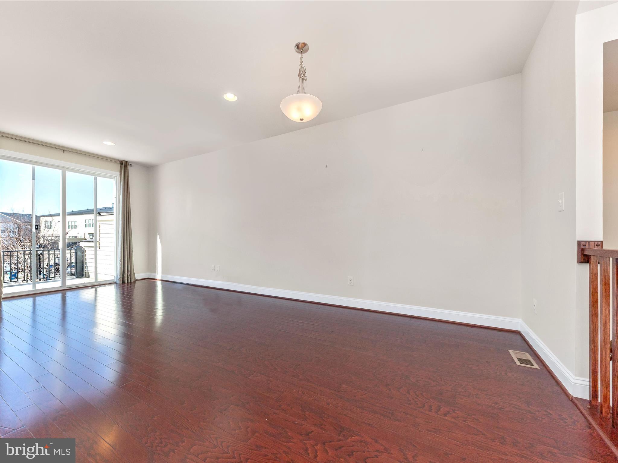 42251 Riggins Ridge Terrace Brambleton, VA 20148 - Photo 24 of 62 a view of an empty room with wooden floor and a window