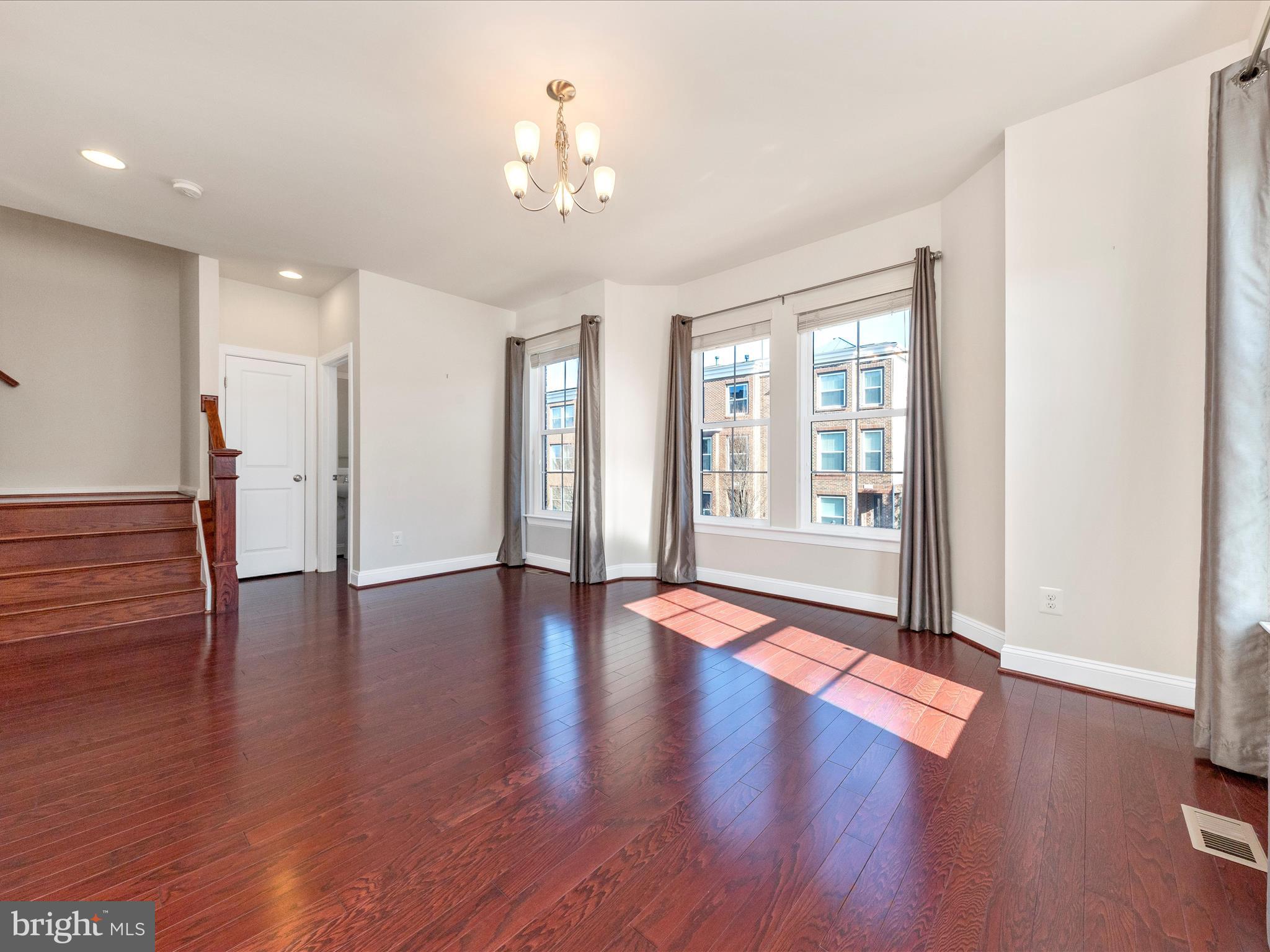 42251 Riggins Ridge Terrace Brambleton, VA 20148 - Photo 27 of 62 a view of an empty room with wooden floor and a window