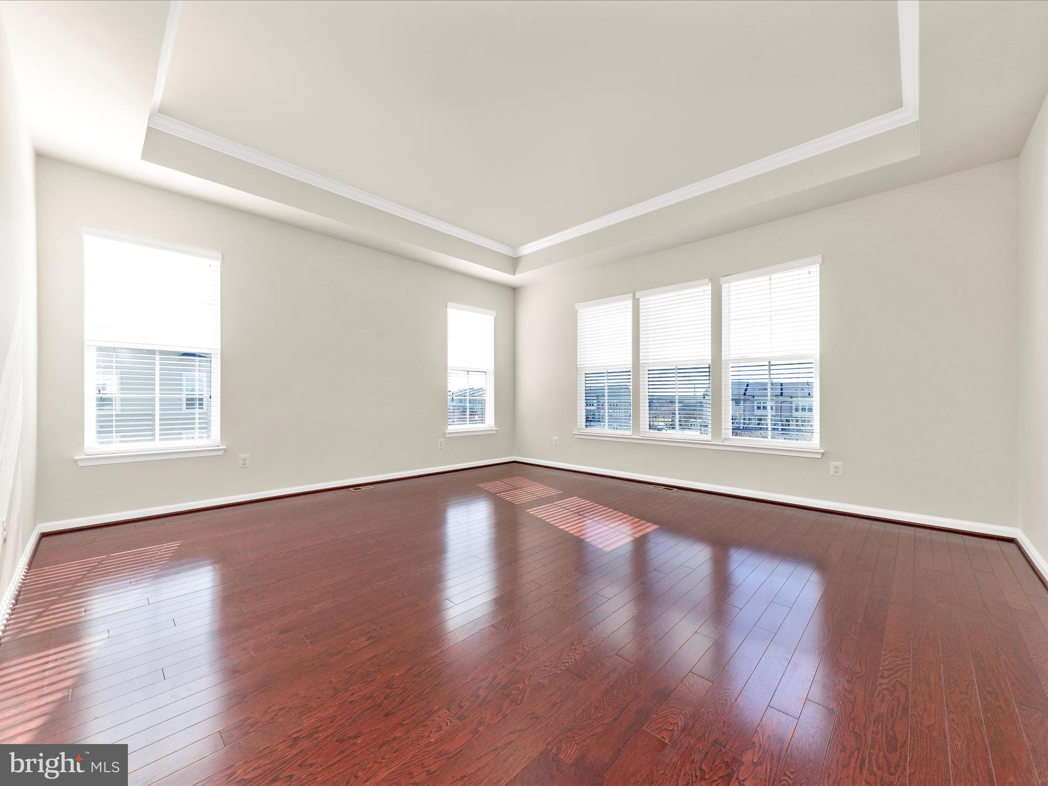 42251 Riggins Ridge Terrace Brambleton, VA 20148 - Photo 32 of 62 a view of an empty room with wooden floor and a window