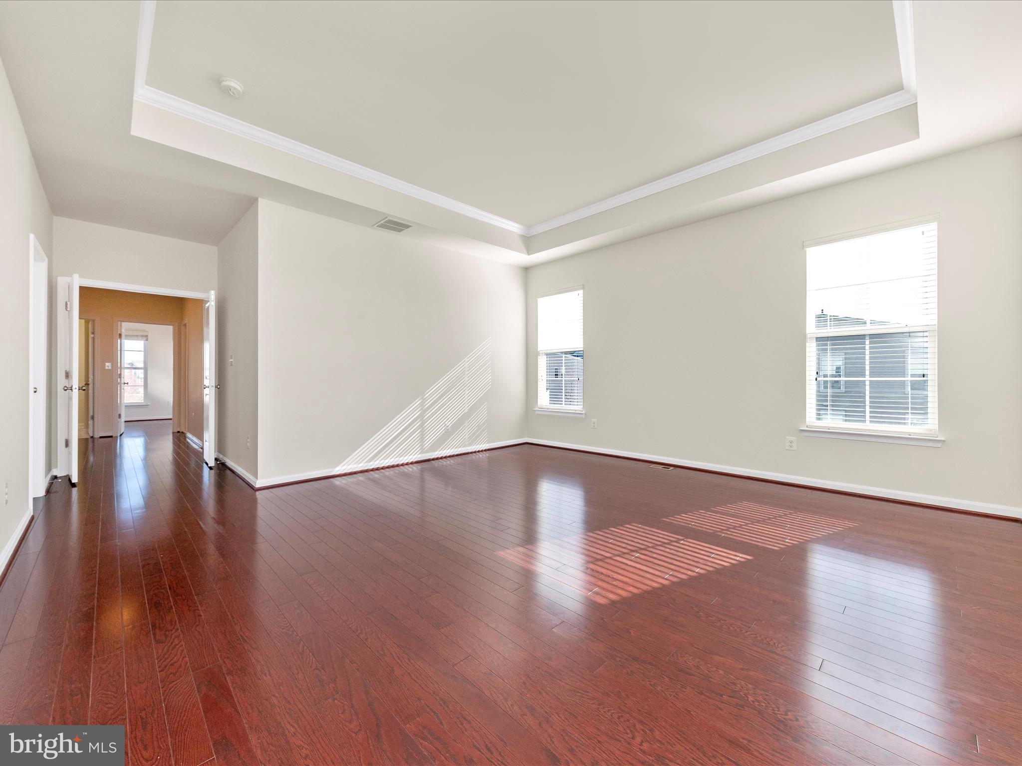 42251 Riggins Ridge Terrace Brambleton, VA 20148 - Photo 35 of 62 a view of an empty room with wooden floor and a window