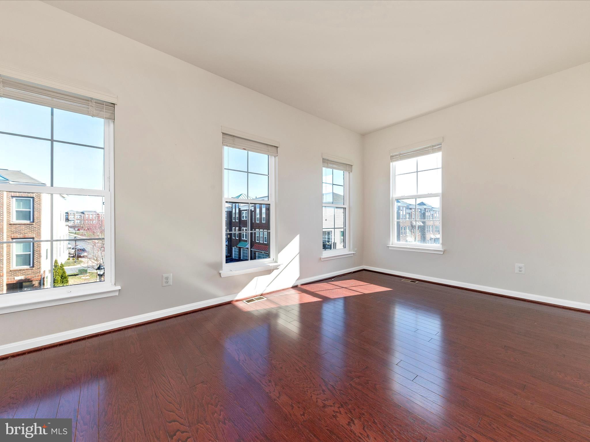 42251 Riggins Ridge Terrace Brambleton, VA 20148 - Photo 38 of 62 an empty room with wooden floor and windows