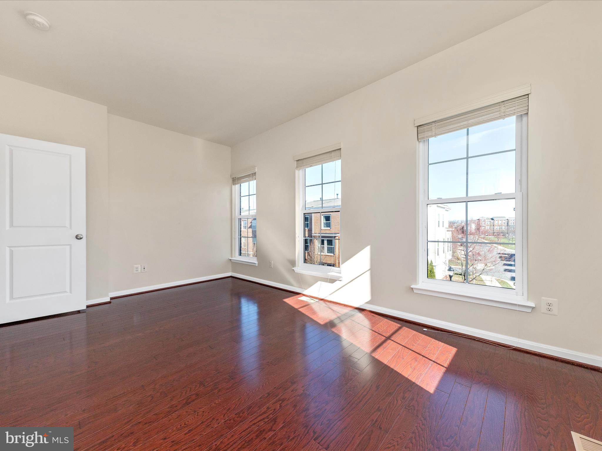 42251 Riggins Ridge Terrace Brambleton, VA 20148 - Photo 39 of 62 a view of empty room with wooden floor and fan