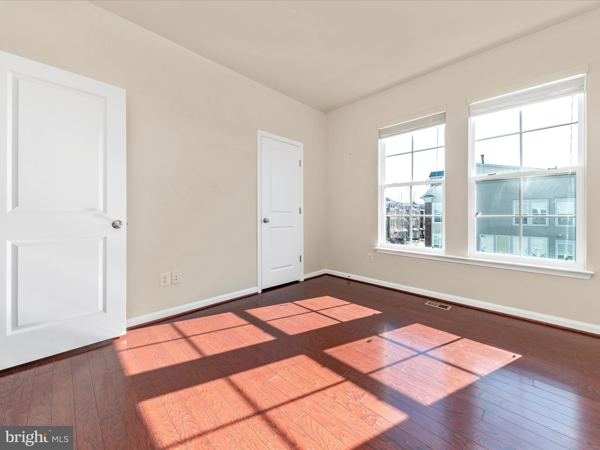 42251 Riggins Ridge Terrace Brambleton, VA 20148 - Photo 41 of 62 an empty room with wooden floor and windows