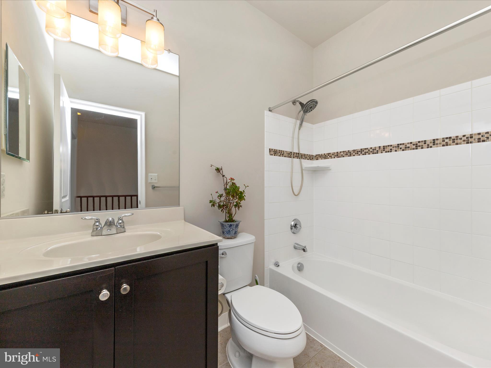 42251 Riggins Ridge Terrace Brambleton, VA 20148 - Photo 42 of 62 a bathroom with a sink a toilet and shower