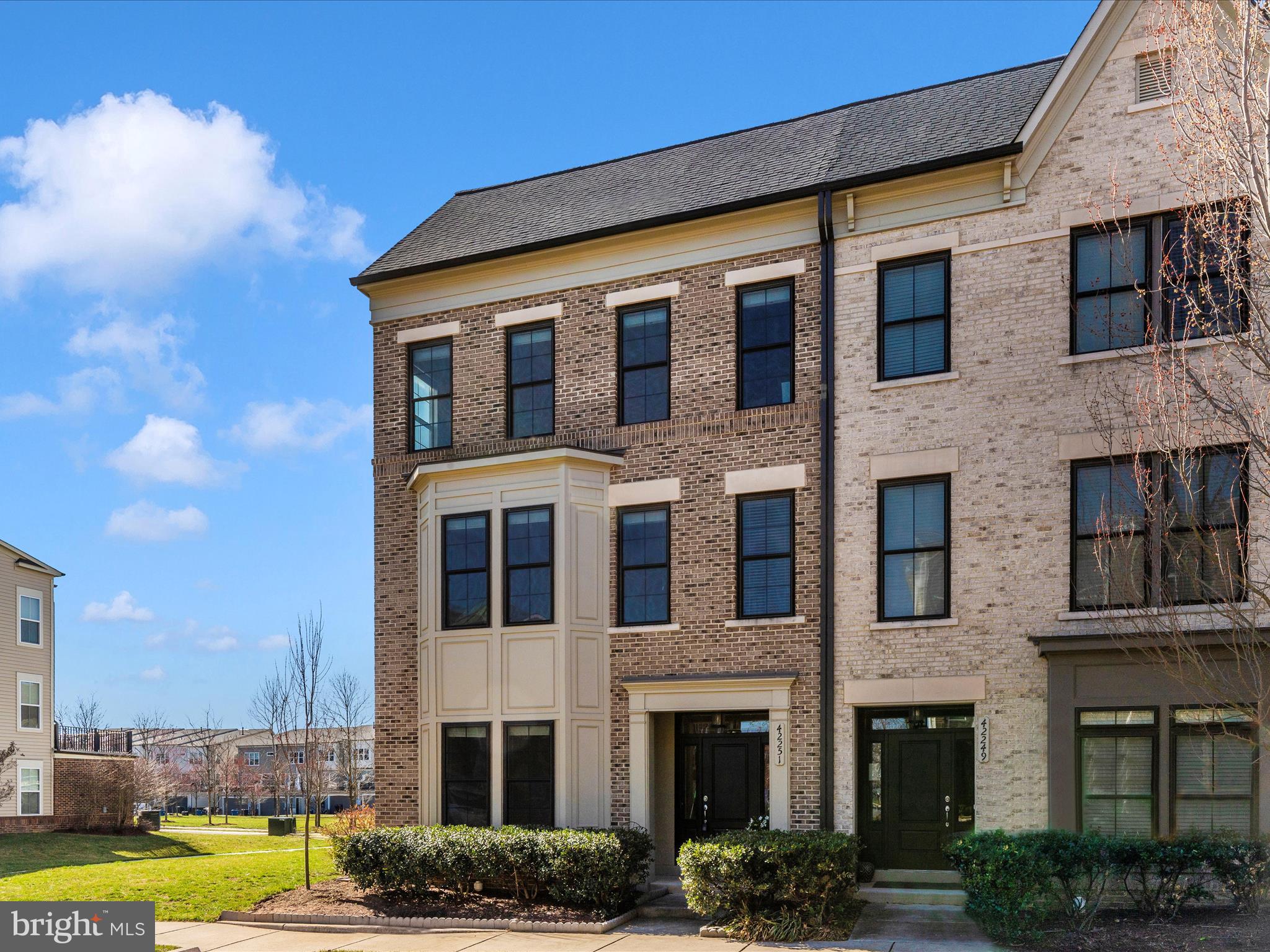 42251 Riggins Ridge Terrace Brambleton, VA 20148 - Photo 49 of 62 a large building with a swimming pool in front of it
