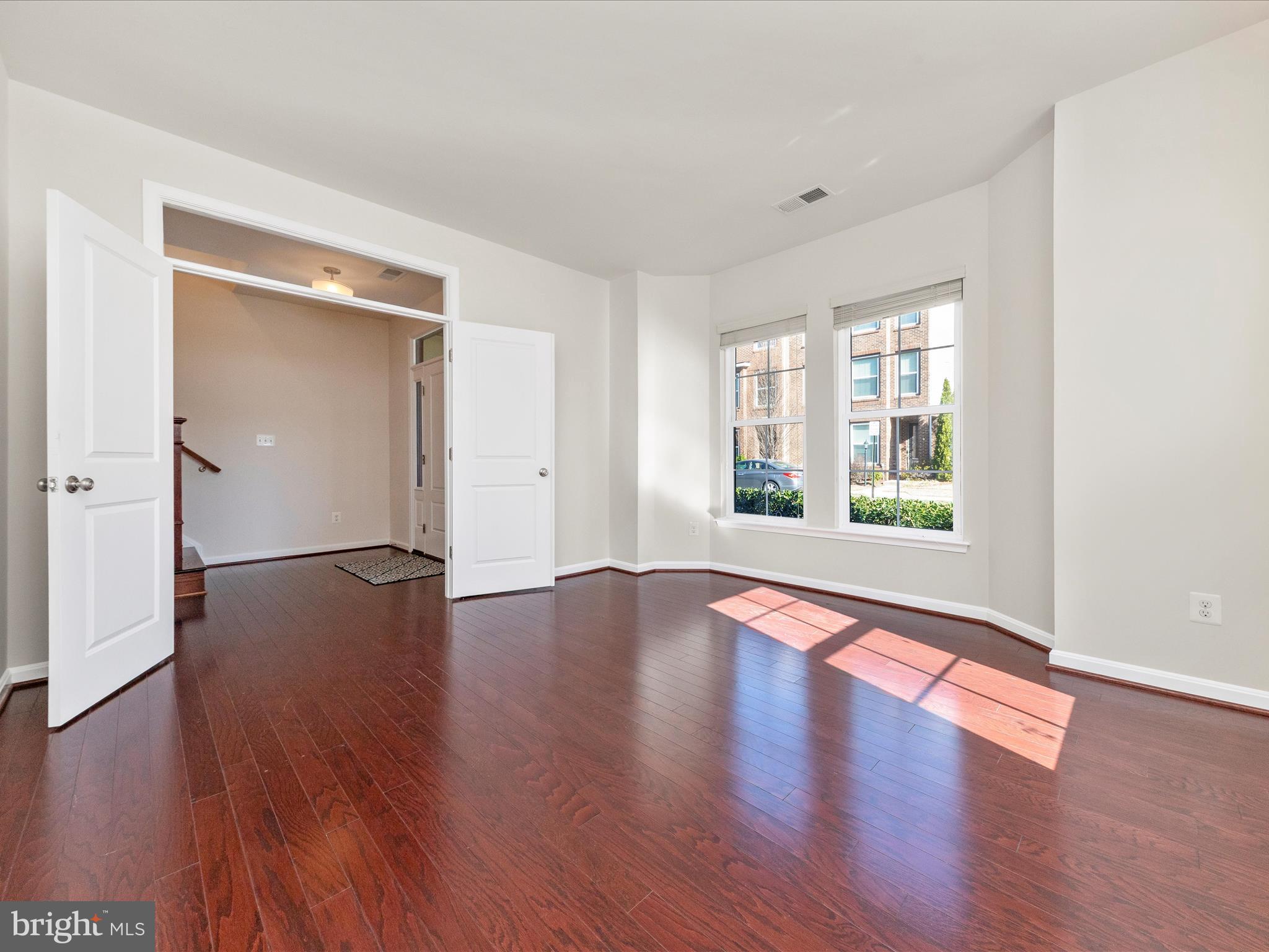 42251 Riggins Ridge Terrace Brambleton, VA 20148 - Photo 5 of 62 an empty room with wooden floor and windows