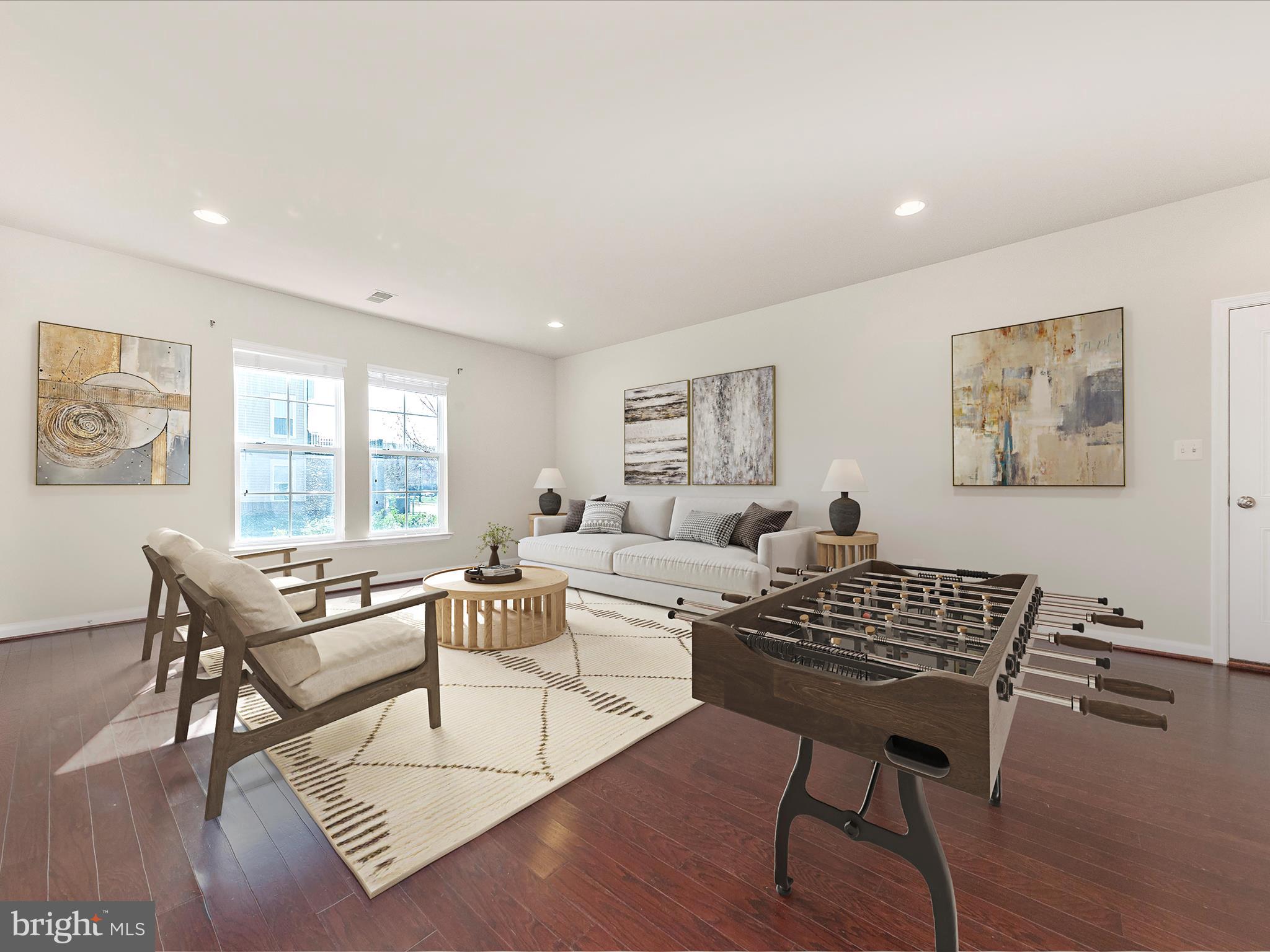 42251 Riggins Ridge Terrace Brambleton, VA 20148 - Photo 6 of 62 a living room with furniture a wooden floor and a window