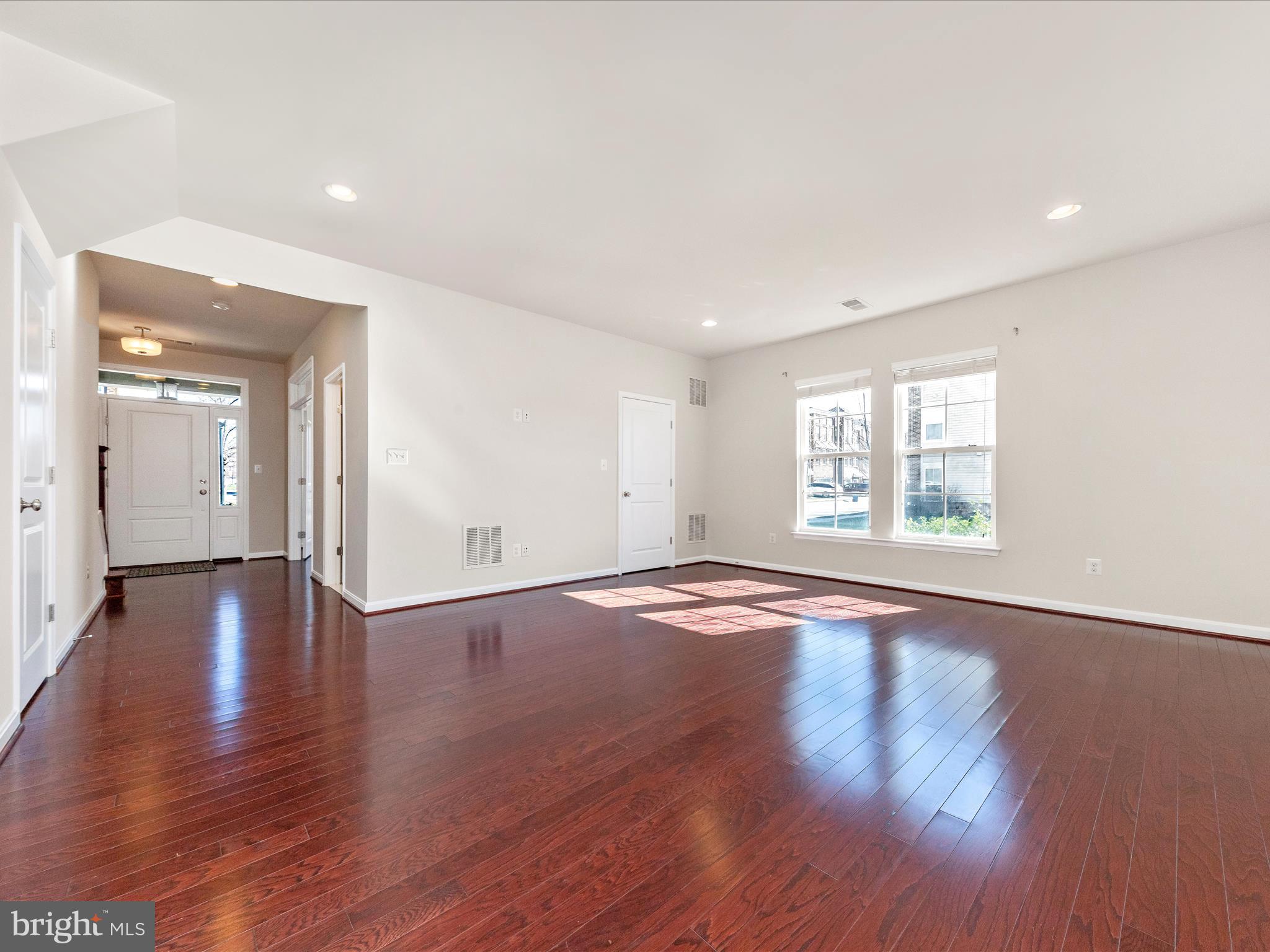 42251 Riggins Ridge Terrace Brambleton, VA 20148 - Photo 9 of 62 an empty room with wooden floor and windows