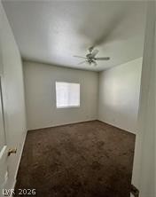 1448 Star Road, Unit 2 Pahrump, NV 89048 - Photo 5 of 10 A well-lit bedroom features plush carpeting and a ceiling fan for comfort.