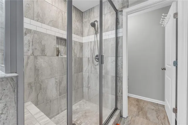 a bathroom with a glass shower door