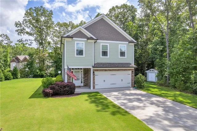 a front view of a house with a garden