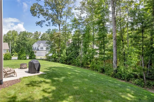 a backyard of a house with table and chairs