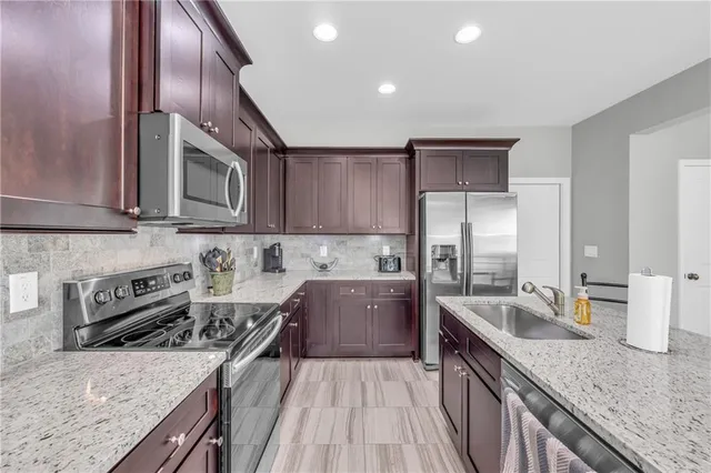 a kitchen with a stove sink and cabinets