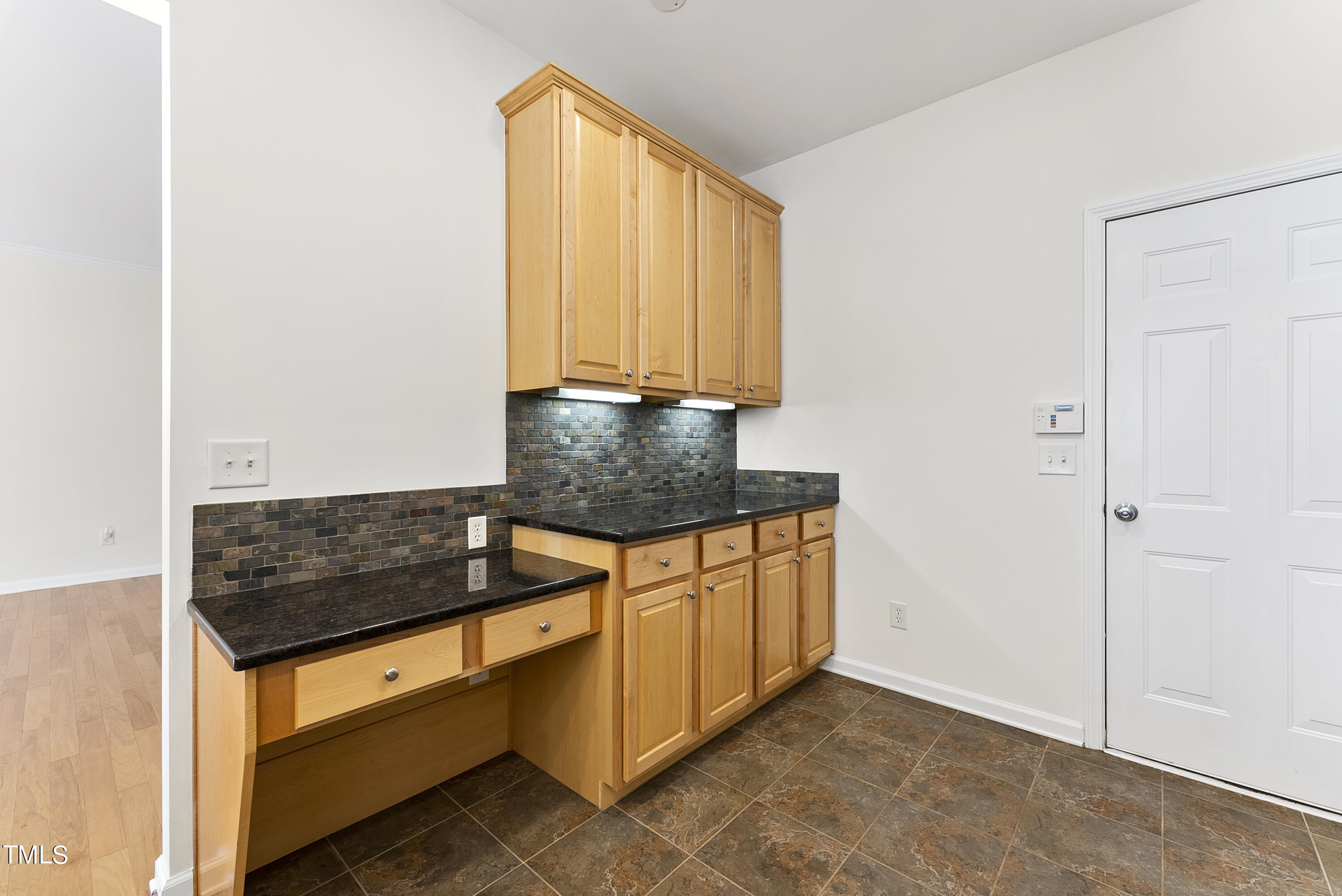 7717 Tanby Court Raleigh, NC 27613 - Photo 17 of 33 a kitchen with granite countertop cabinets and black appliances