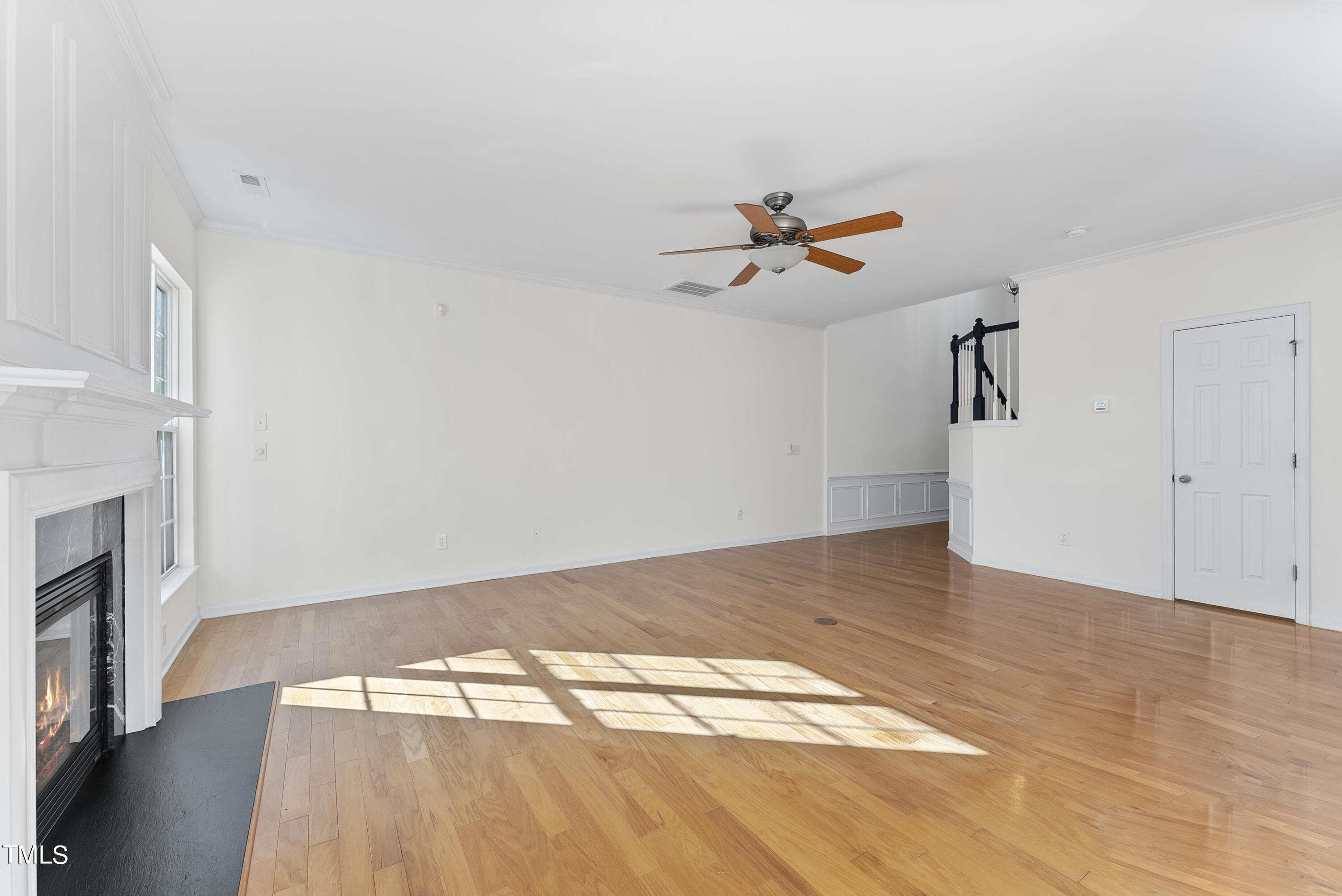 7717 Tanby Court Raleigh, NC 27613 - Photo 10 of 33 a view of empty room with wooden floor and fan