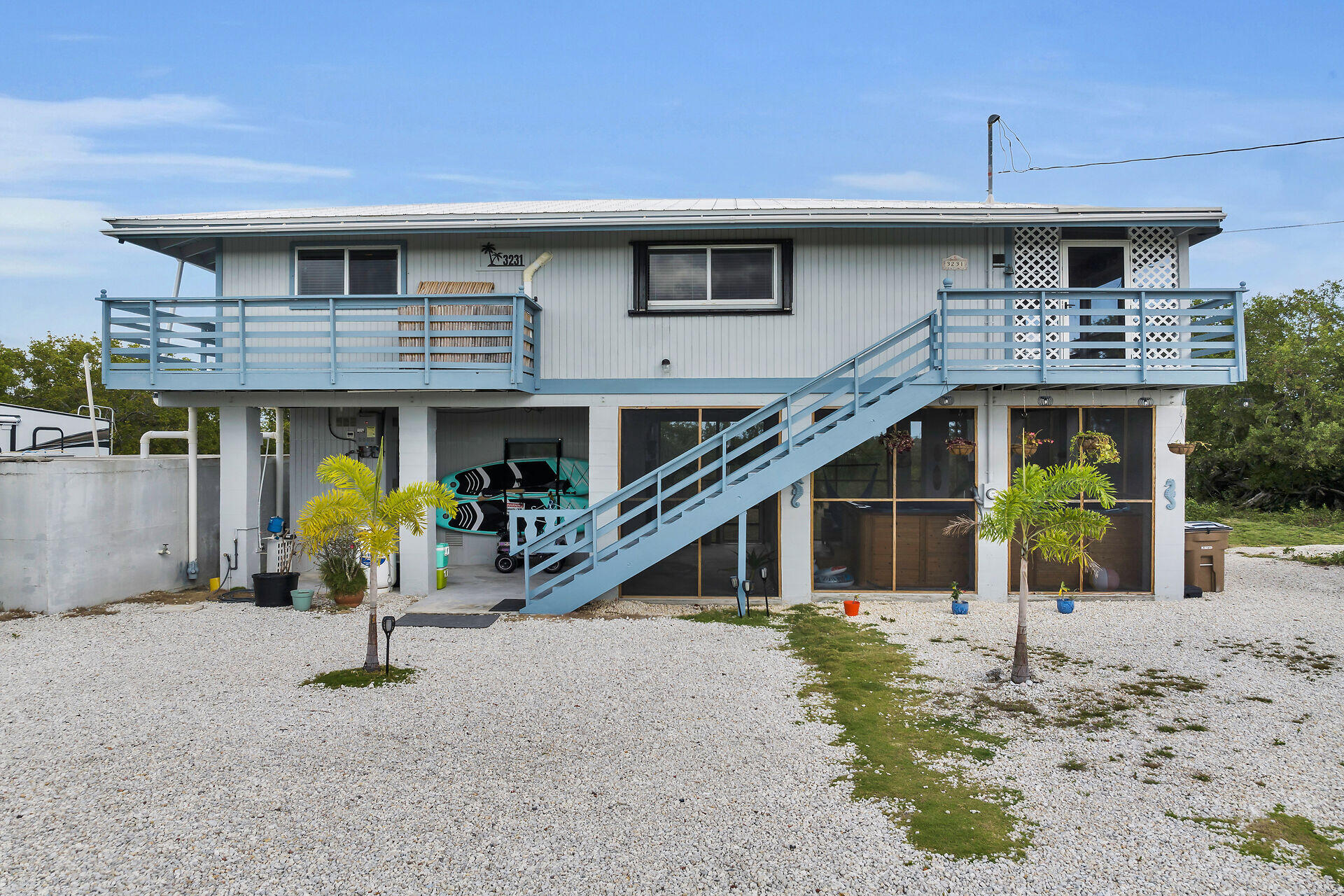 3231 Pompano Street Big Pine Key, FL 33043 - Photo 1 of 42 a front view of a house with garden