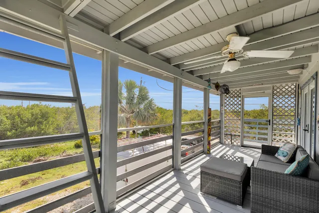 a dining room with stainless steel appliances a dining table and chairs