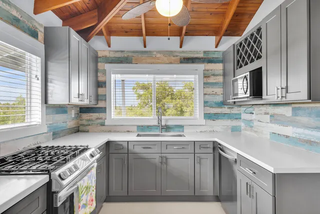 a living room with furniture a flat screen tv and a window