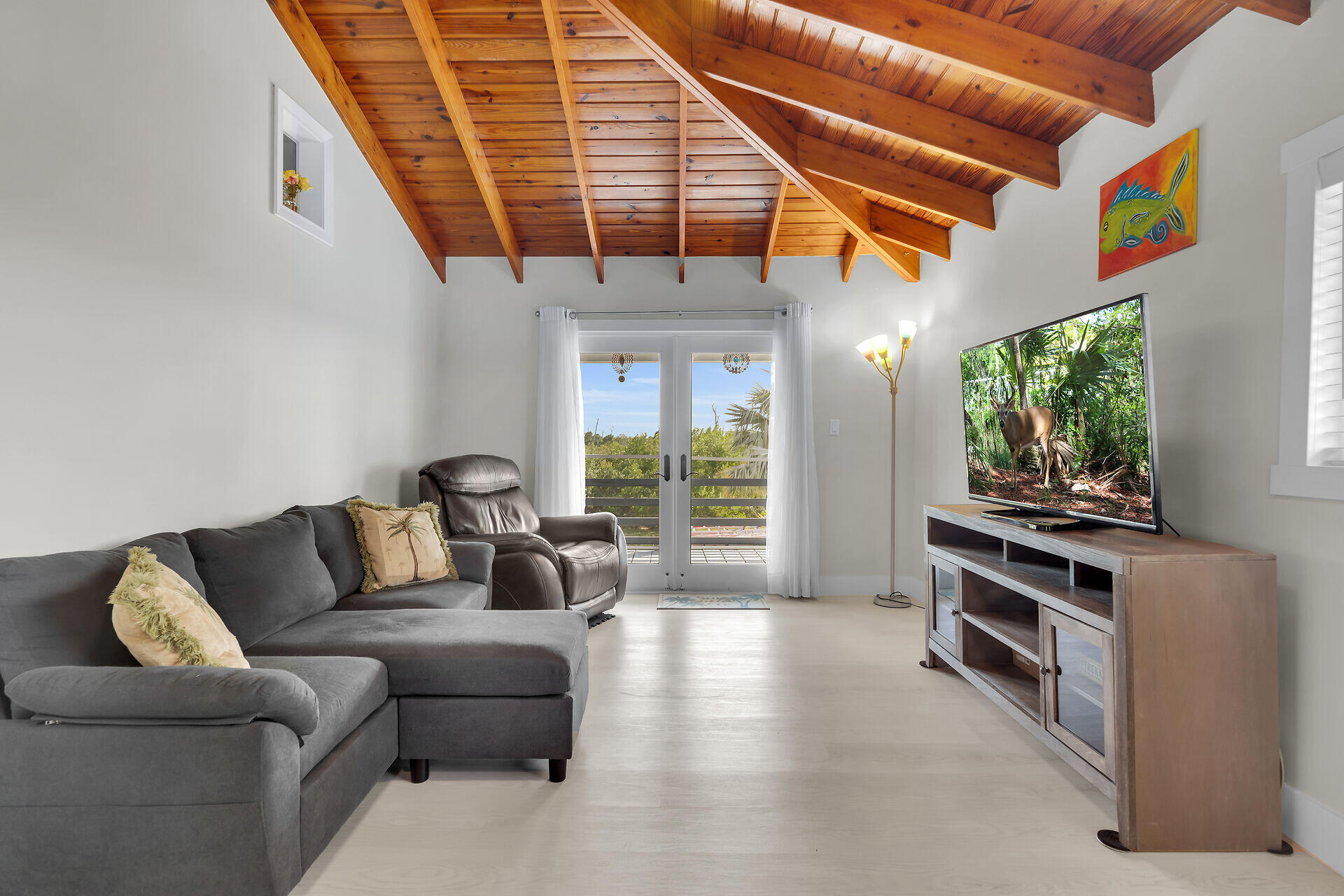3231 Pompano Street Big Pine Key, FL 33043 - Photo 27 of 42 a living room with furniture a flat screen tv and a window