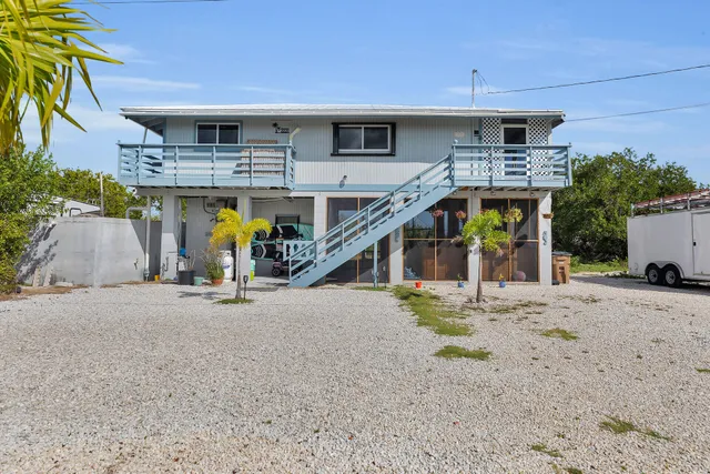 a view of a house with tub and wooden fence