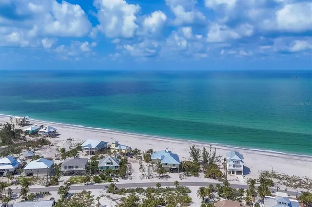a view of a dry yard with wooden fence