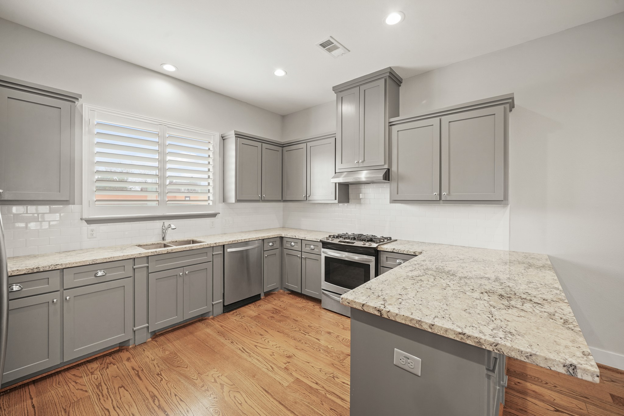 2547 Calumet Street Houston, TX 77004 - Photo 11 of 28 a kitchen with a stove sink and cabinets