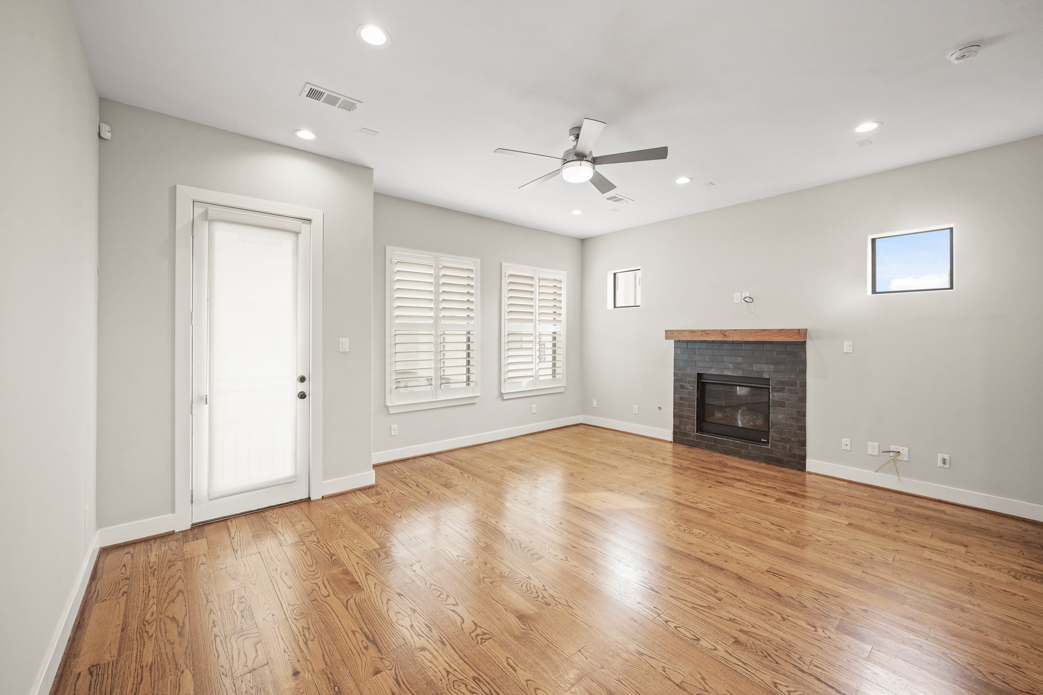 2547 Calumet Street Houston, TX 77004 - Photo 13 of 28 an empty room with windows fireplace and wooden floor