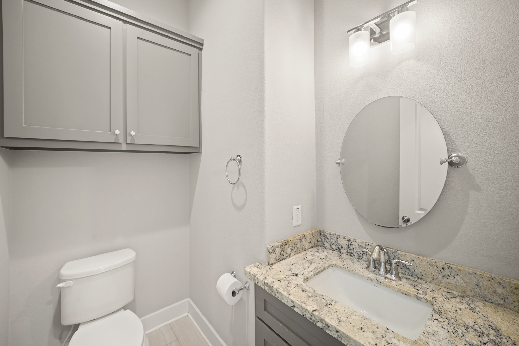 2547 Calumet Street Houston, TX 77004 - Photo 9 of 28 a bathroom with a granite countertop sink a mirror and a toilet