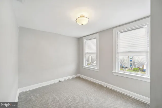 a view of a roof deck with couches and wooden floor