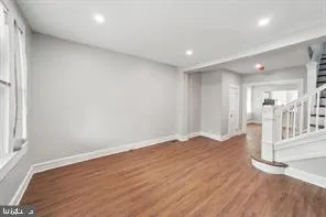 a view of wooden floor and windows in a room