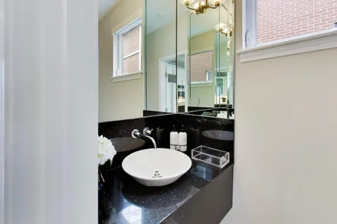 a bathroom with a sink mirror vanity and a toilet