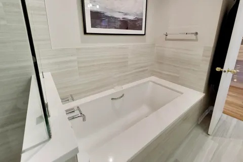 a bath tub sitting next to a white sink