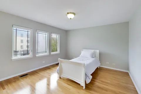 a spacious bedroom with a bed and a window