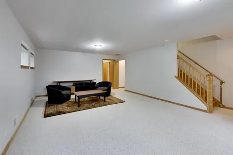 a living room with furniture and a ceiling fan
