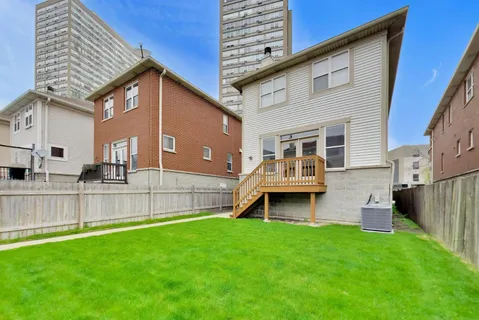 a front view of a house with a yard and outdoor seating