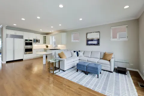 a living room with lots of furniture and kitchen view